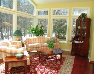 sun rt corner after The client was going to discard these sofas. They have since been reupholstered in a flax linen and she is thrilled. Angling the furniture allowed for connectivity to the family room and freed up space for the bistro corner.